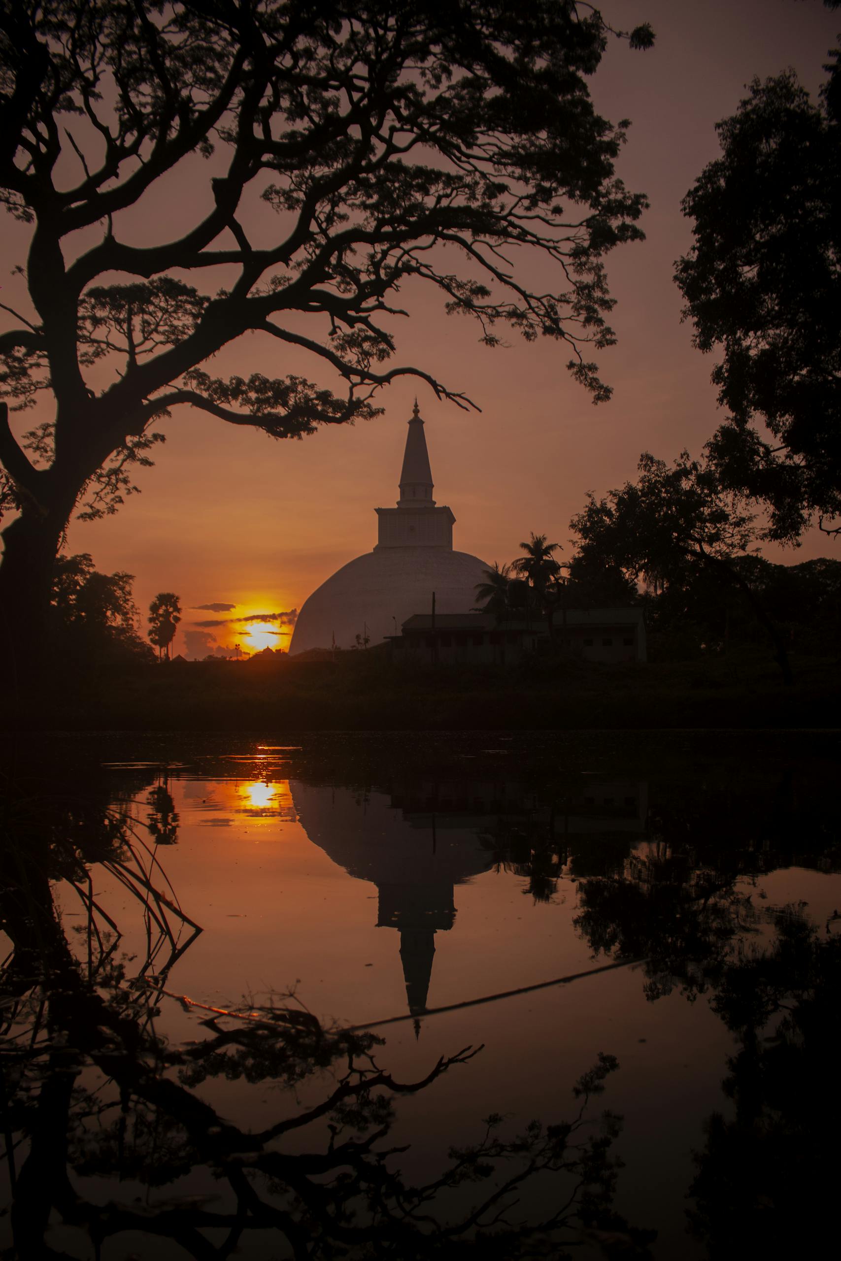 Captivating view of Ruwanwelisaya Stupa with sunset reflection in Anuradhapura.